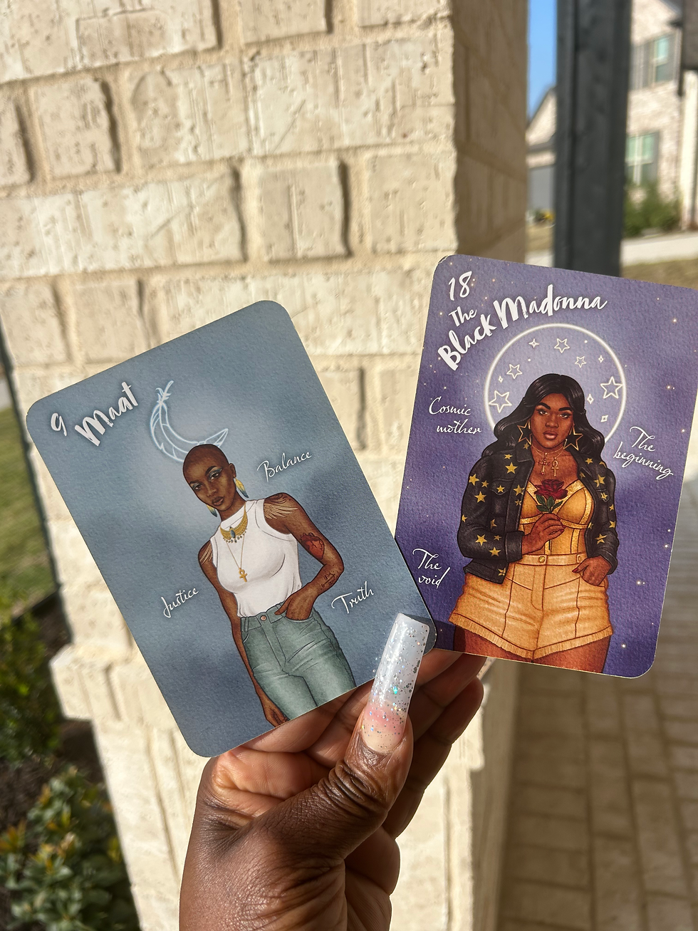 two oracle cards with pictures of beautiful melanin women in a hand with long nails and a brick wall in the background.