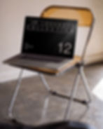 macbook mockup, amber acrylic chair, chrome frame, raw plaster wall, polished concrete, design studio mockup, made by attic