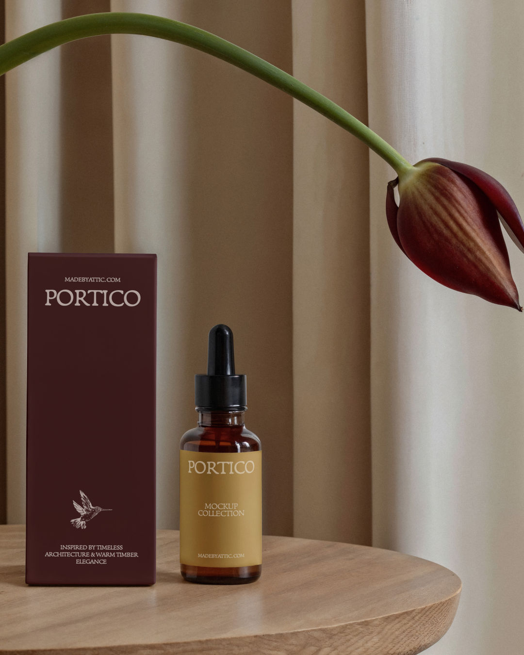 A high-fidelity dropper bottle and box mockup on a warm timber surface with a single tulip bowing over the scene.