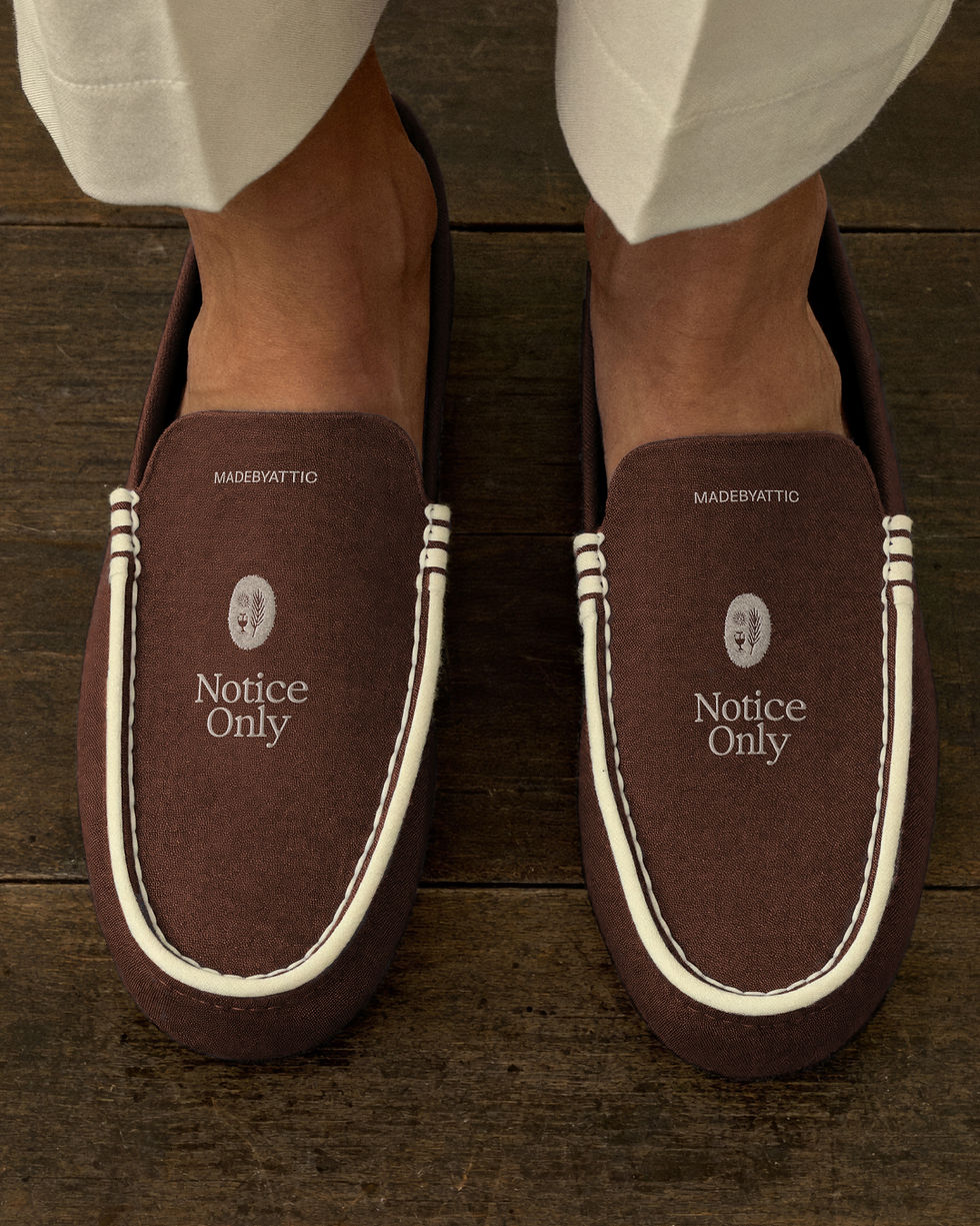 suede slipper mockup, house slippers worn on timber floor, cream piped edge, vamp branding, blue and brown colourways, hotel