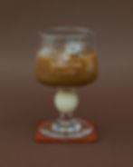 iced coffee glass mockup, footed glass on terracotta coaster, etched branding, espresso and blue backgrounds, hospitality bra