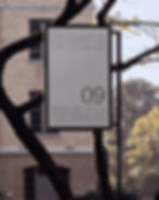 banner mockup, pole banner, bare tree branches, brick building, autumn light, institutional signage mockup, made by attic