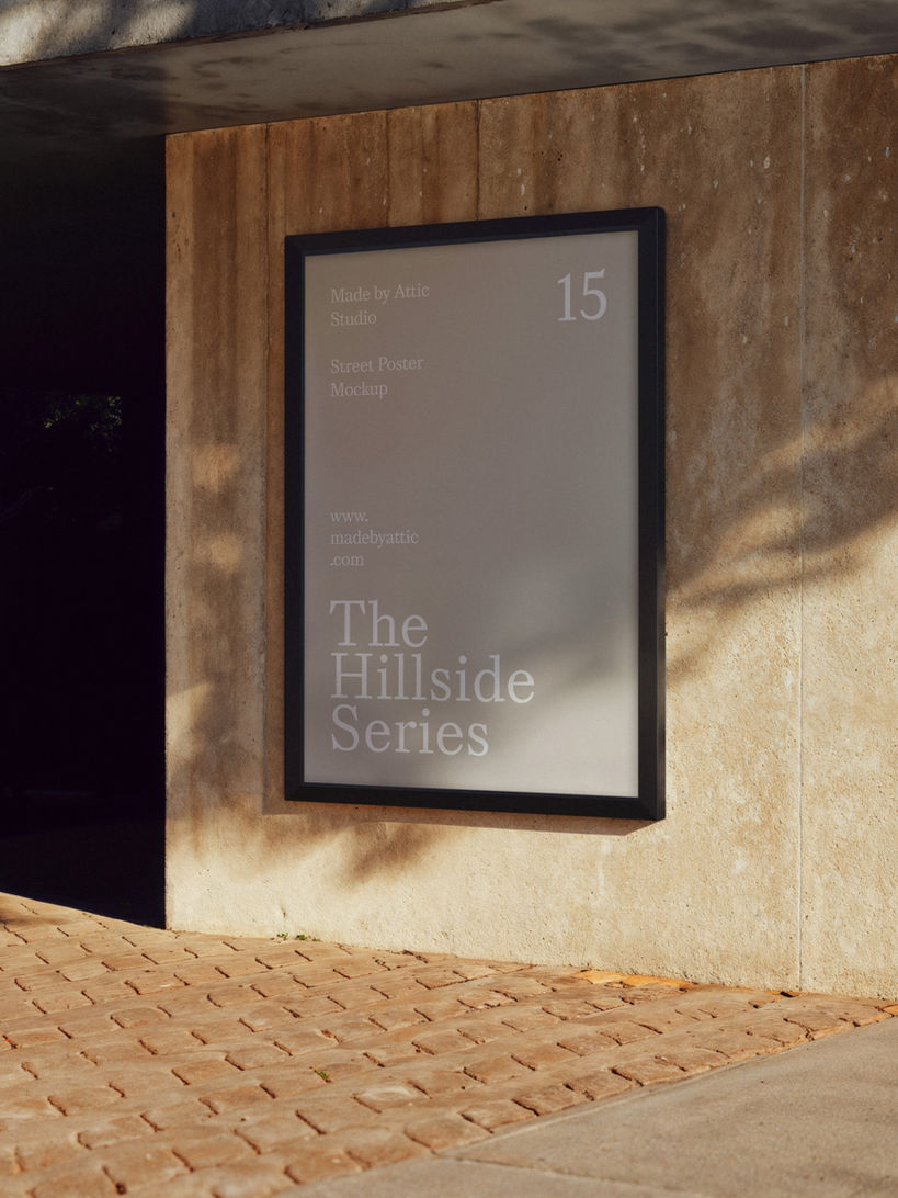 A photorealistic street poster mockup mounted on a concrete wall with dappled sunlight shadows.