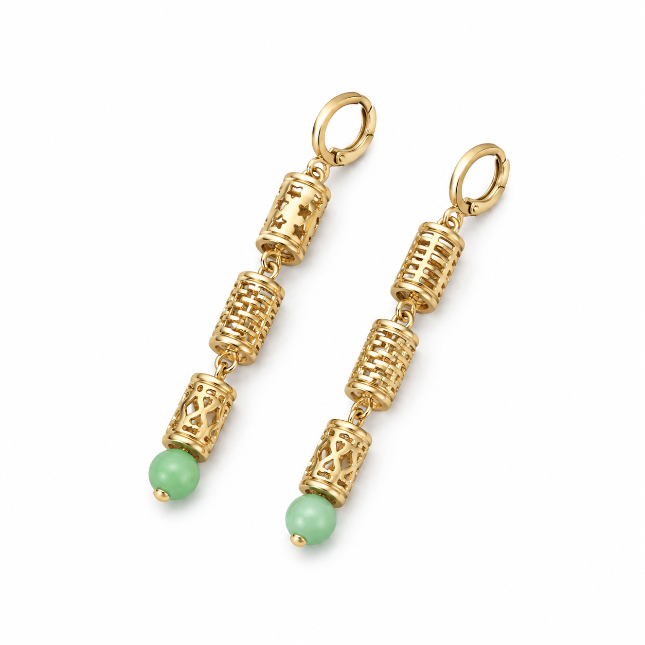 Long gold drop earrings with green cat’s eye beads on white background