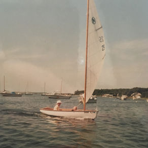 Father and daughter in a small sailboat