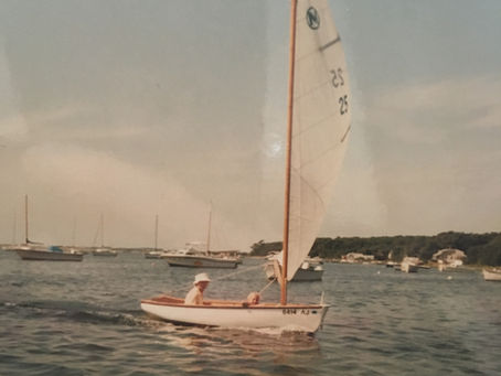Father and daughter in a small sailboat