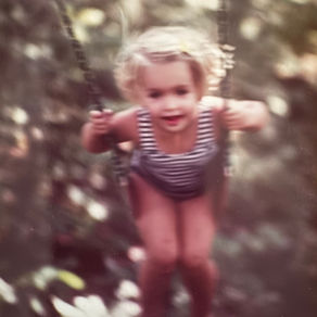 A young girl swinging