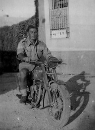 arthur-britton-on-motorcyle-with-contras