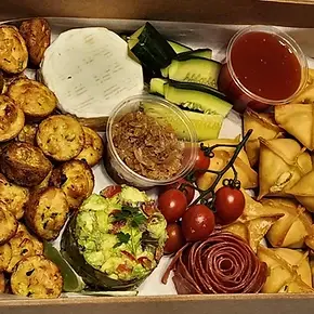 Savory catering box with samosas, cheese, and vegetables