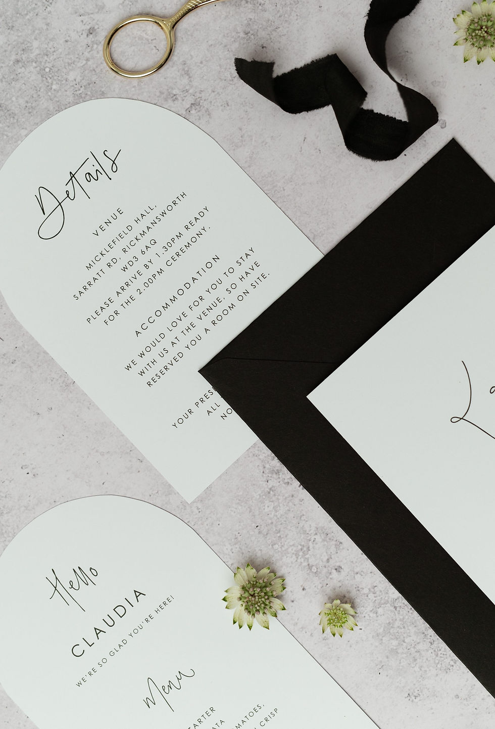 A monochrome wedding stationery collection with shaped card and a moonlike calligraphy style.