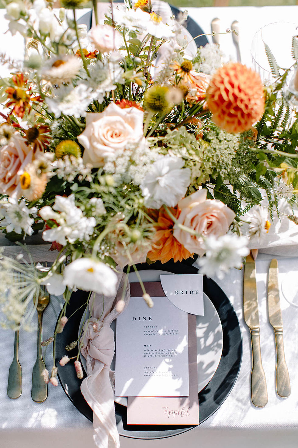 Sustainable wedding stationery on table with flowers