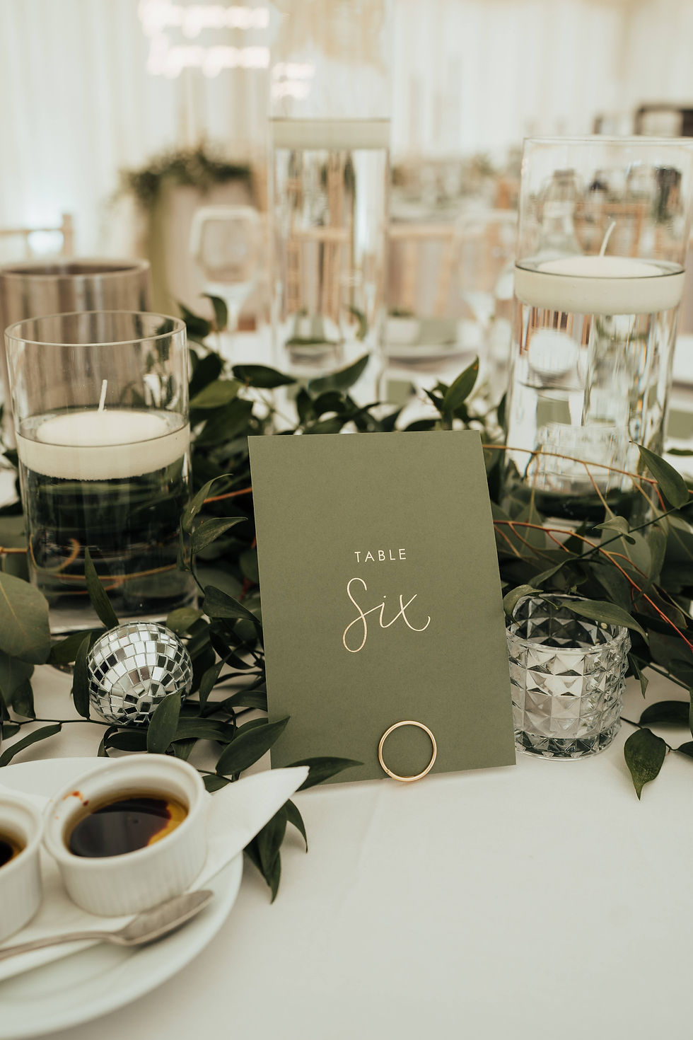 A table number with white calligraphy on green card