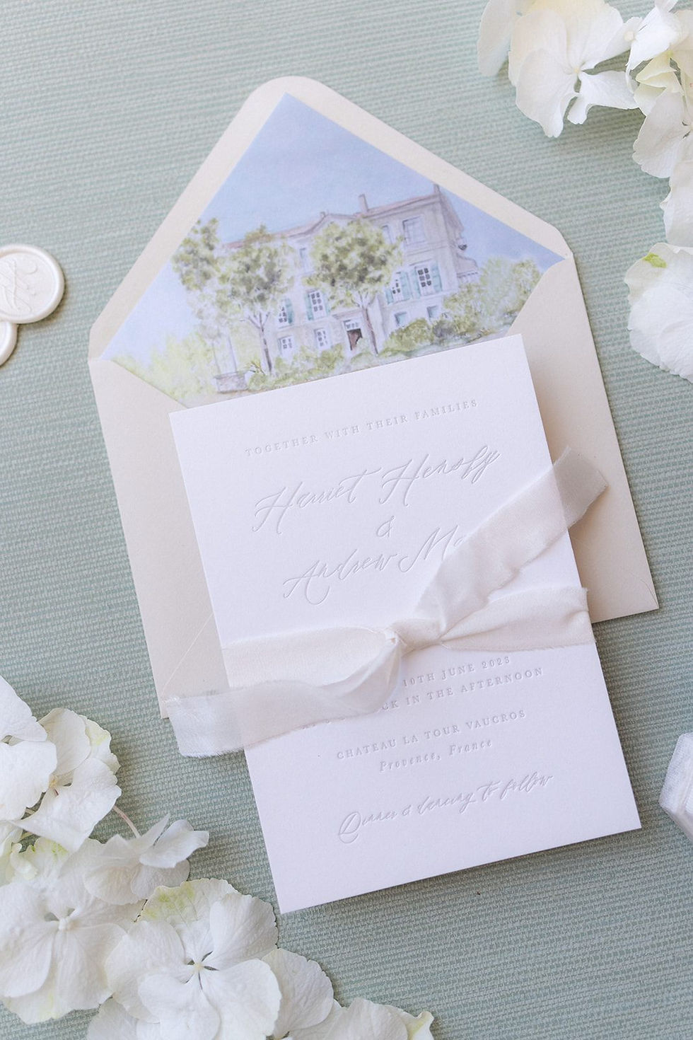 An elegant wedding invitation with a traditional calligraphy style with letterpress printing and a watercolour venue illustration.