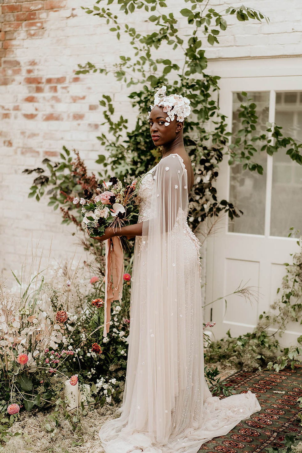 Bride in dress with fairy tale sleeves and bespoke floral headpiece