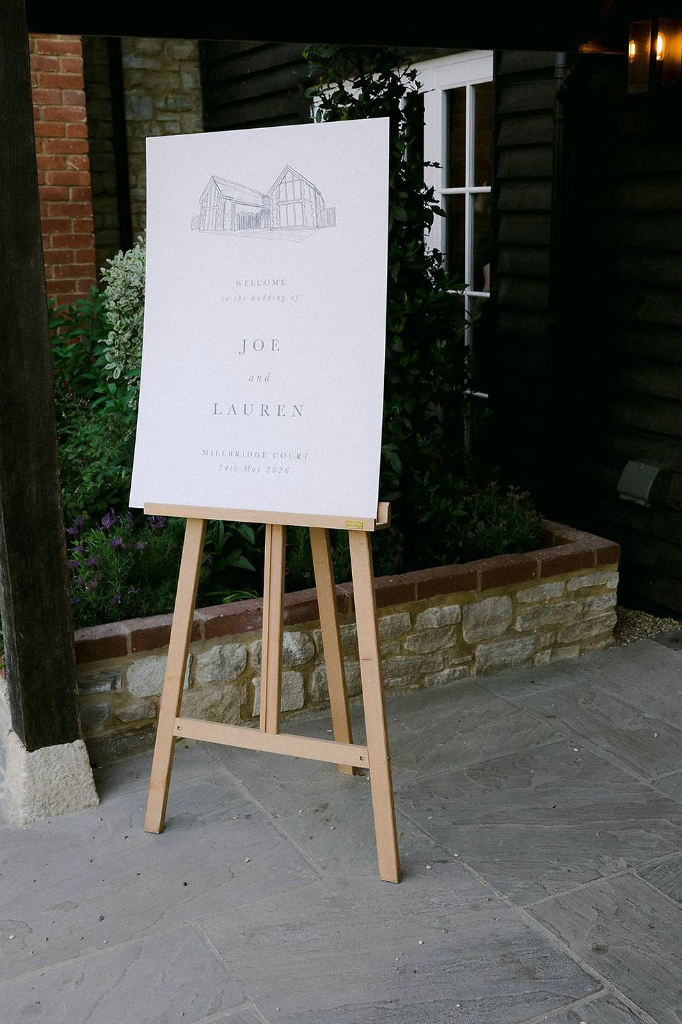 Wedding welcome sign with a wedding venue illustration on an easel