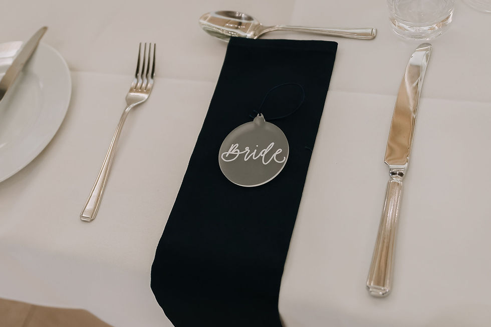 Bauble shaped place name with calligraphy on frosted perspex.