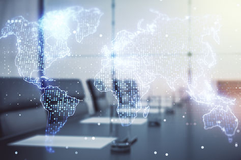 Digital world map overlay displayed in a modern office setting, representing global connectivity, data networks, and international business communication.