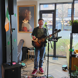 Ken Jones playing guitar at a corporate event in Dublin