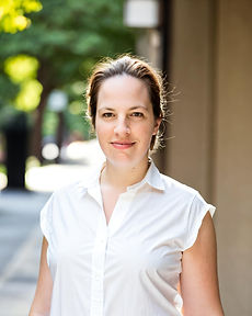 Professional Therapist Smiling Wearing White Shirt in Urban Environment