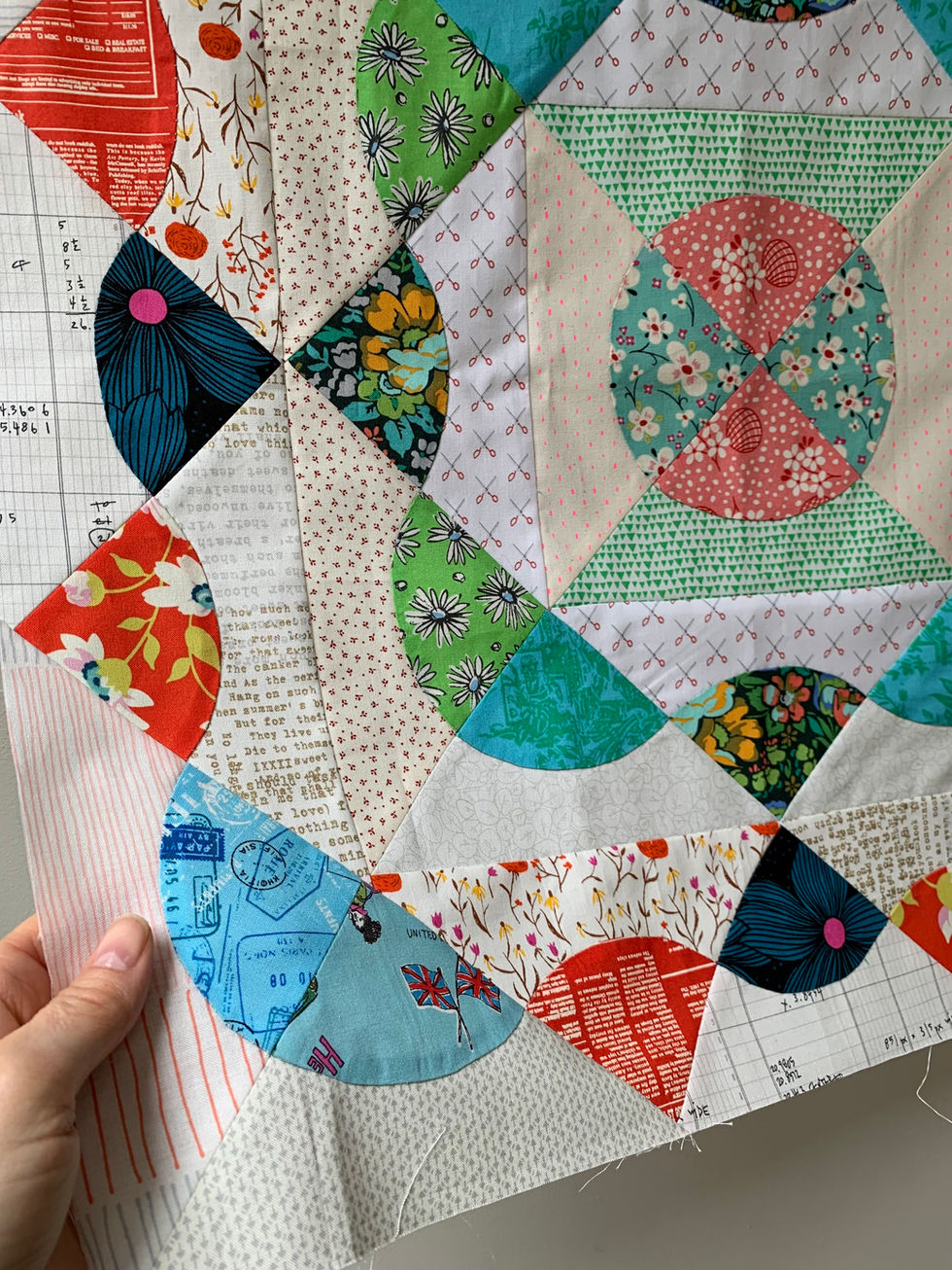 Sector quilt made from a circle applique to secondary quilt blocks