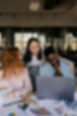 A diverse group of professionals engage in a strategy session, reflecting a dynamic and creative work culture. Perfect for brands seeking expert marketing leadership in the fashion and beauty industry.