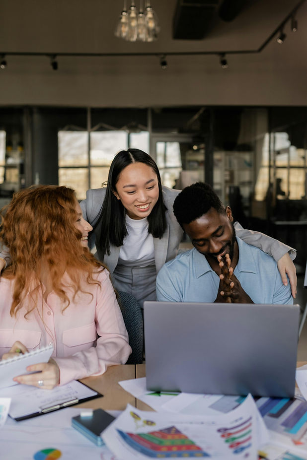 A diverse group of professionals engage in a strategy session, reflecting a dynamic and creative work culture. Perfect for brands seeking expert marketing leadership in the fashion and beauty industry.