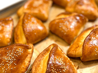 Homemade Hungarian sandwich pockets baked golden brown and topped with sesame seeds.