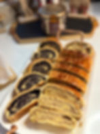 Platter of sliced Hungarian beigli with walnut and poppy seed fillings, traditional Christmas pastry.