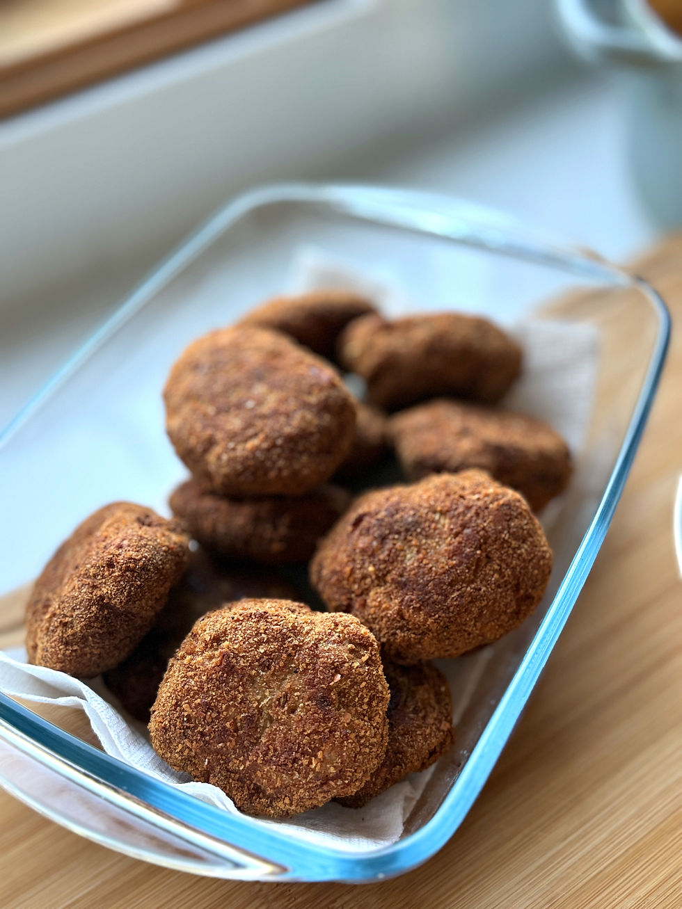 Tray filled with golden-brown breadcrumb-coated Hungarian beef patties resting on paper towels.