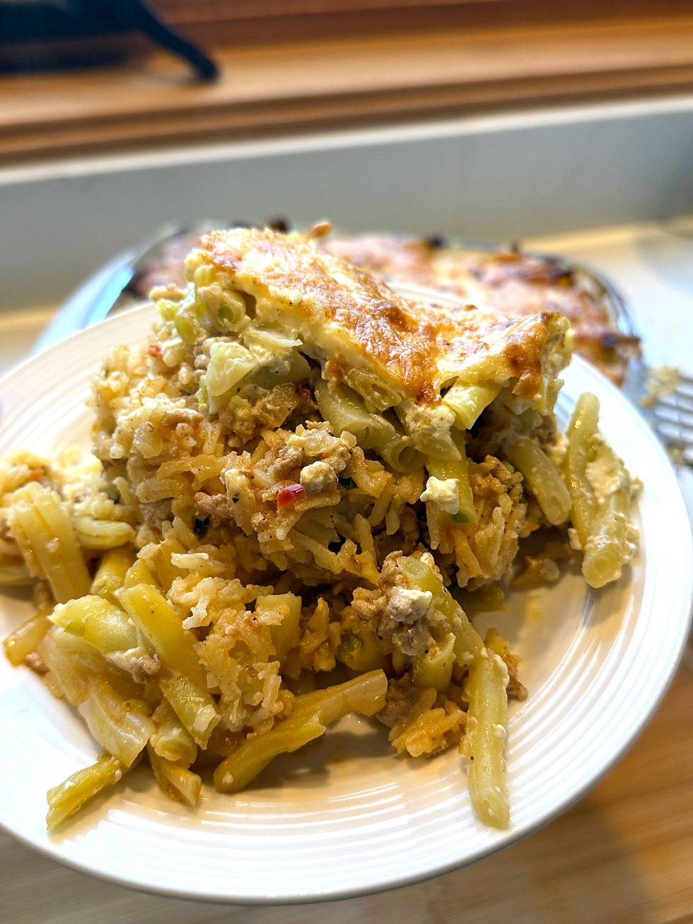 Forkful of Hungarian rakott zöldbab with yellow wax beans, ground beef and rice.