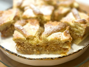 Two slices of Hungarian almás pite showing a thick grated apple and cinnamon filling between golden pastry layers.