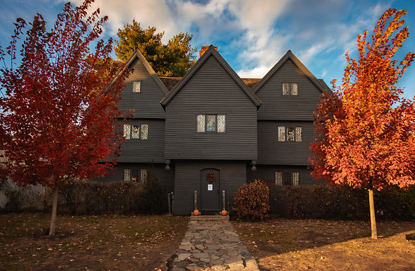 The Salem Witch House in Fall with bright red trees out front.jpg