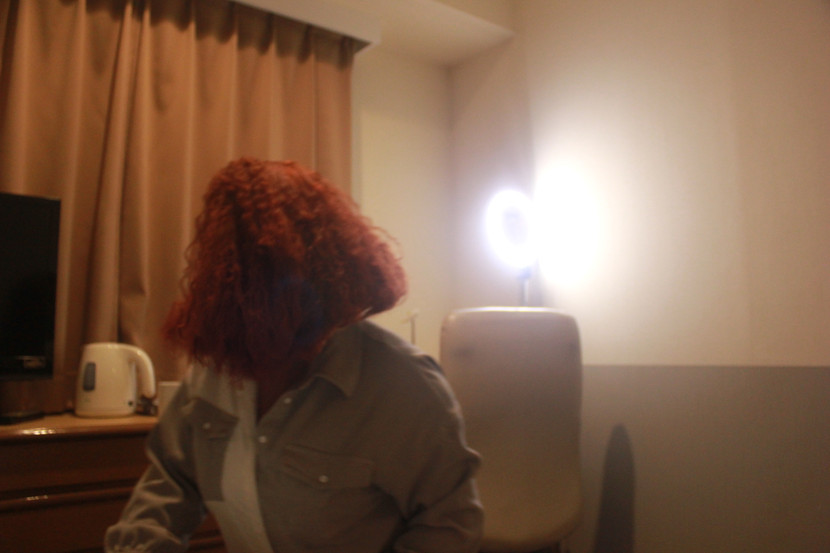 A black girl with red hair looking away from the camera 
