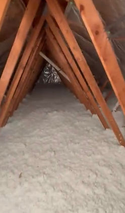 Attic with perfectly installed blown-in insulation and a reflective solar radiant barrier, fully insulated for energy efficie
