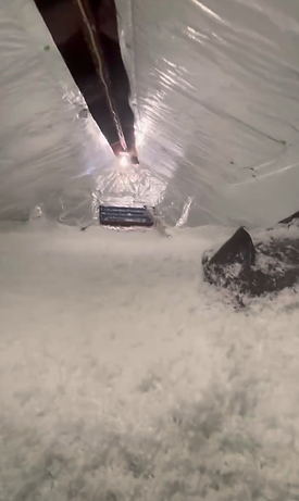 Attic with perfectly installed blown-in insulation and a reflective solar radiant barrier, fully insulated for energy efficie