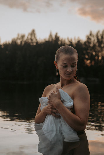 nainen vedessä valkoisen lakanan kanssa 