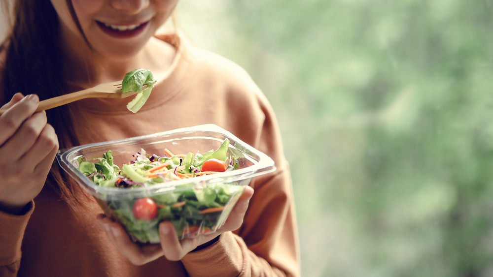 Woman eating salad