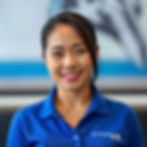 Filipina lady wearing blue polo shirt with DoneDeskVA logo on the left side of the shirt o