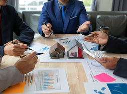 A group of professionals analysing housing data
