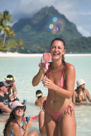 Magical birthday event on a Bora Bora motu with golden sunset light and cheerful moments.