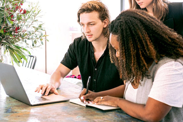 Two people taking notes