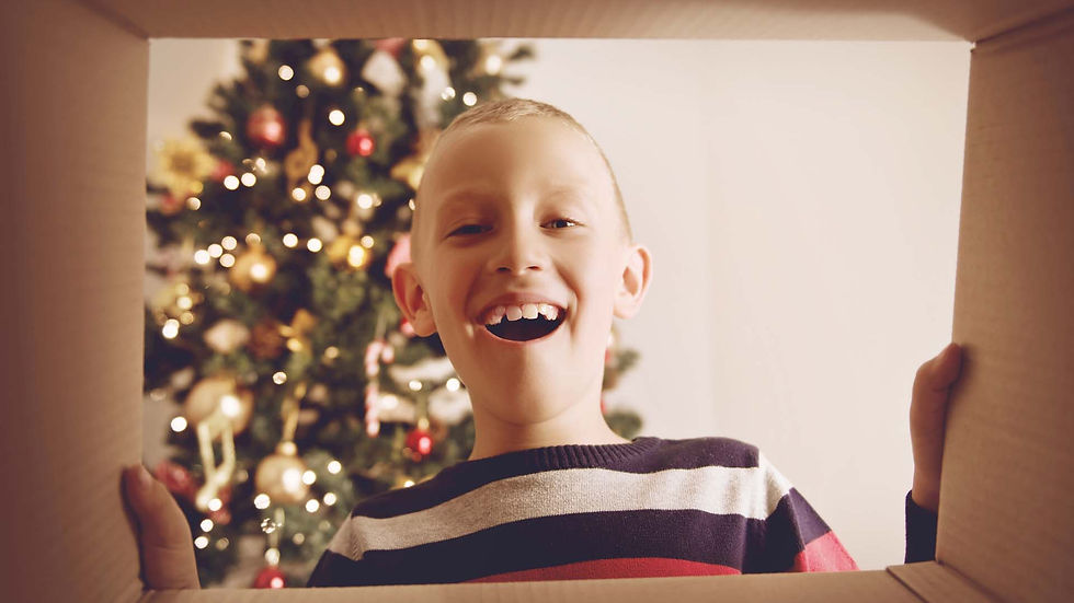 Child opening Christmas Gift from Fostering Christmas