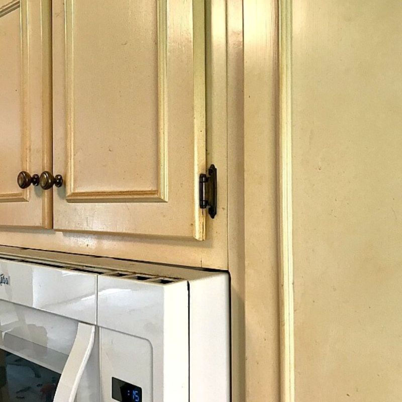 close-up of kitchen cabinets that are stained and need to be properly prepped before cabinet painting for best durability