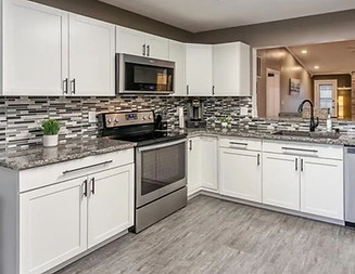 Kitchen cabinet painting in Mesa AZ with white refinished cabinets and neutral walls.