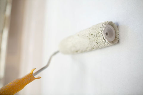 close-up of a paint roller on an interior wall