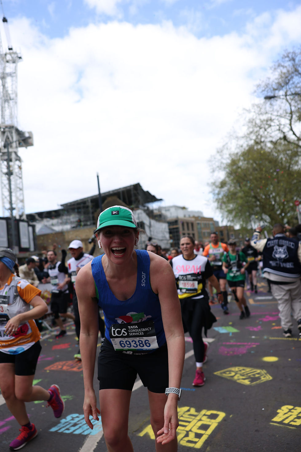 Laura Fletcher running the London Marathon at Mile 21 with Run Dem Crew