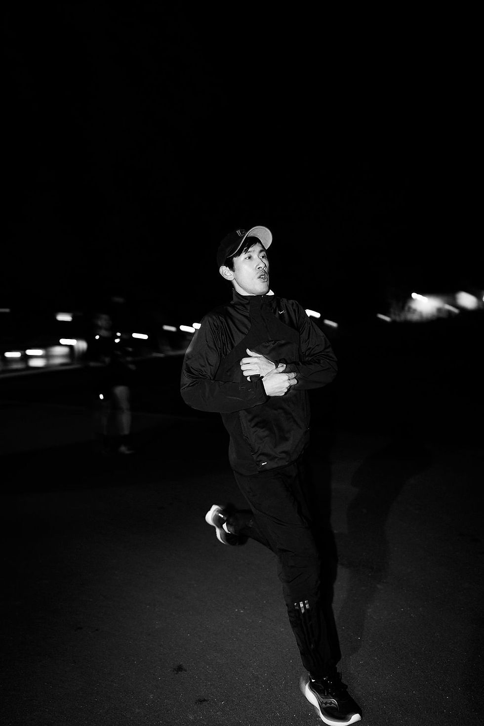 Runner checking their watch on track