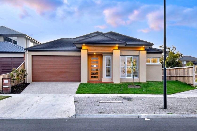 Modern melbourne property with a front lawn and garage