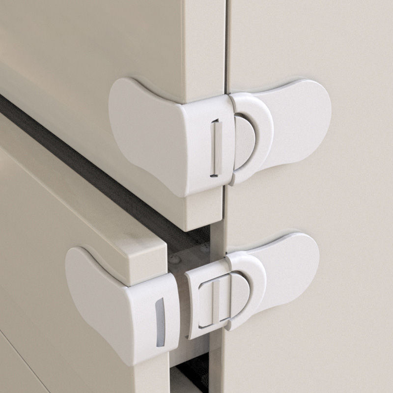 White child safety cabinet locks installed on drawers.