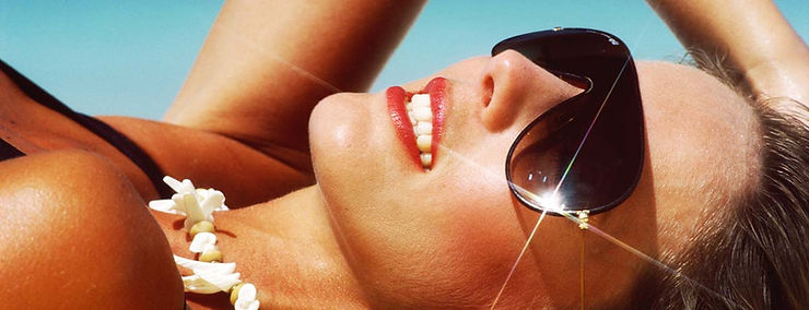 Girl tanning. How sunscreen helps to prevent premature skin aging